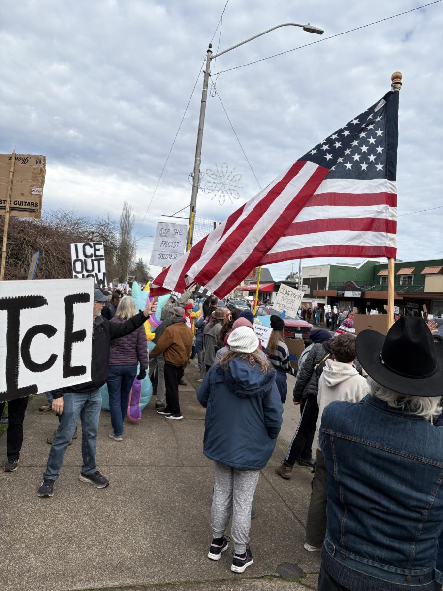 Protestors line the street with signs, showing their support of ICE removal. The protest was on Saturday, Jan. 10, in downtown Corvallis. 