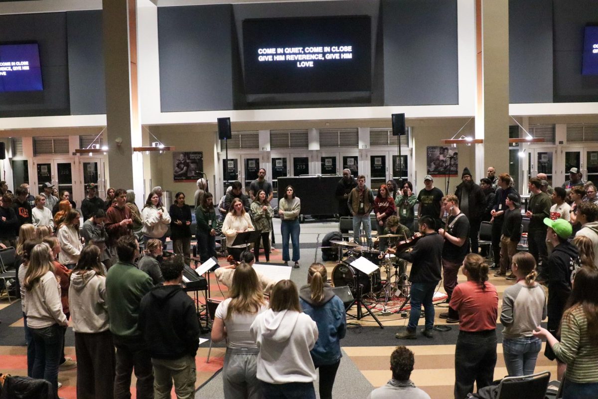 Real Life club and local church members sing together at the Toyota Club in Reser Stadium in Corvallis on the night of Jan. 27. Real Life is one of a few Christian student organizations for Oregon State University students.