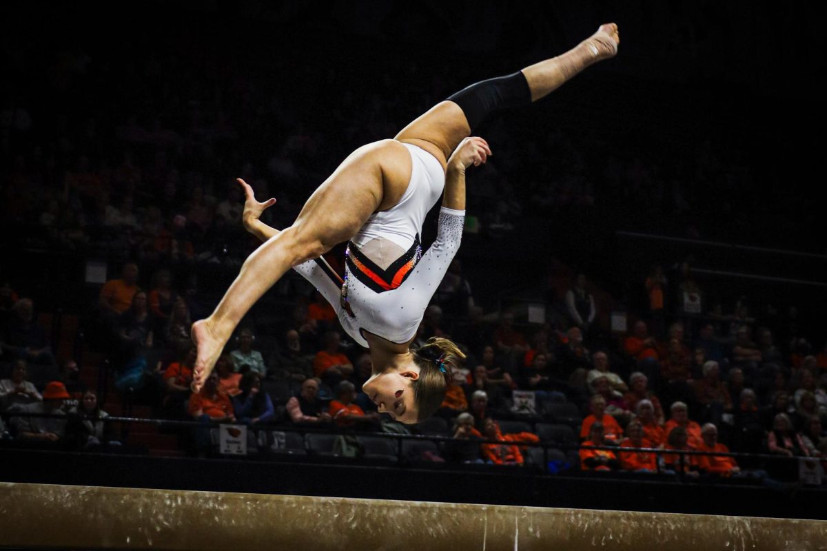 Senior gymnast Lauren Letzsch performs a front aerial on the balance beam at Gill Coliseum on Feb. 14. The Southern Utah University Women’s Gymnastics
team claimed the win against OSU with a final score of 196.825 to 196.300.
