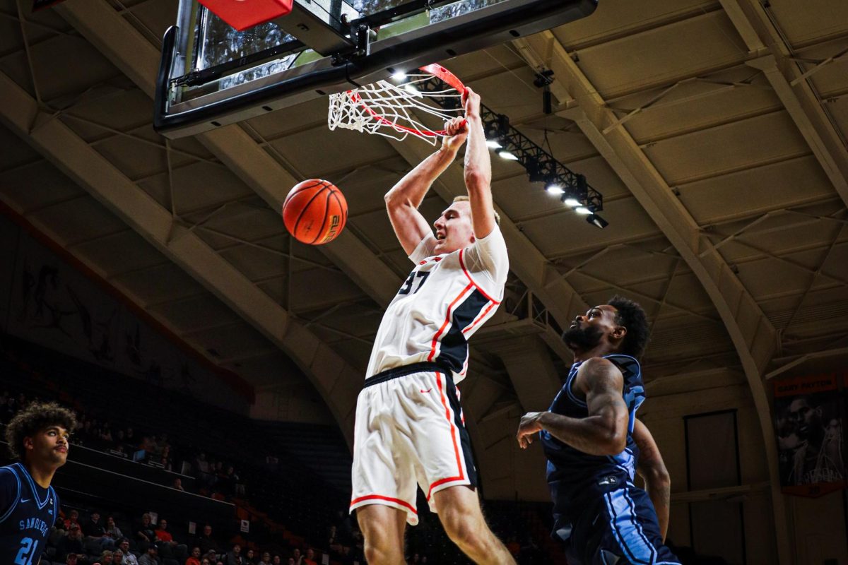 Forward Olavi Suutela (37) hangs on the rim after dunking the ball in Oregon State’s Men’s Basketball game against University of San Diego at Gill Coliseum on February 25, 2026.