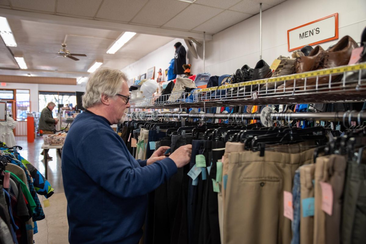 Corvallis Community Thrift floor manager, Rich, browses a clothing rack at the NW 2nd and Jackson Ave location on January 21.