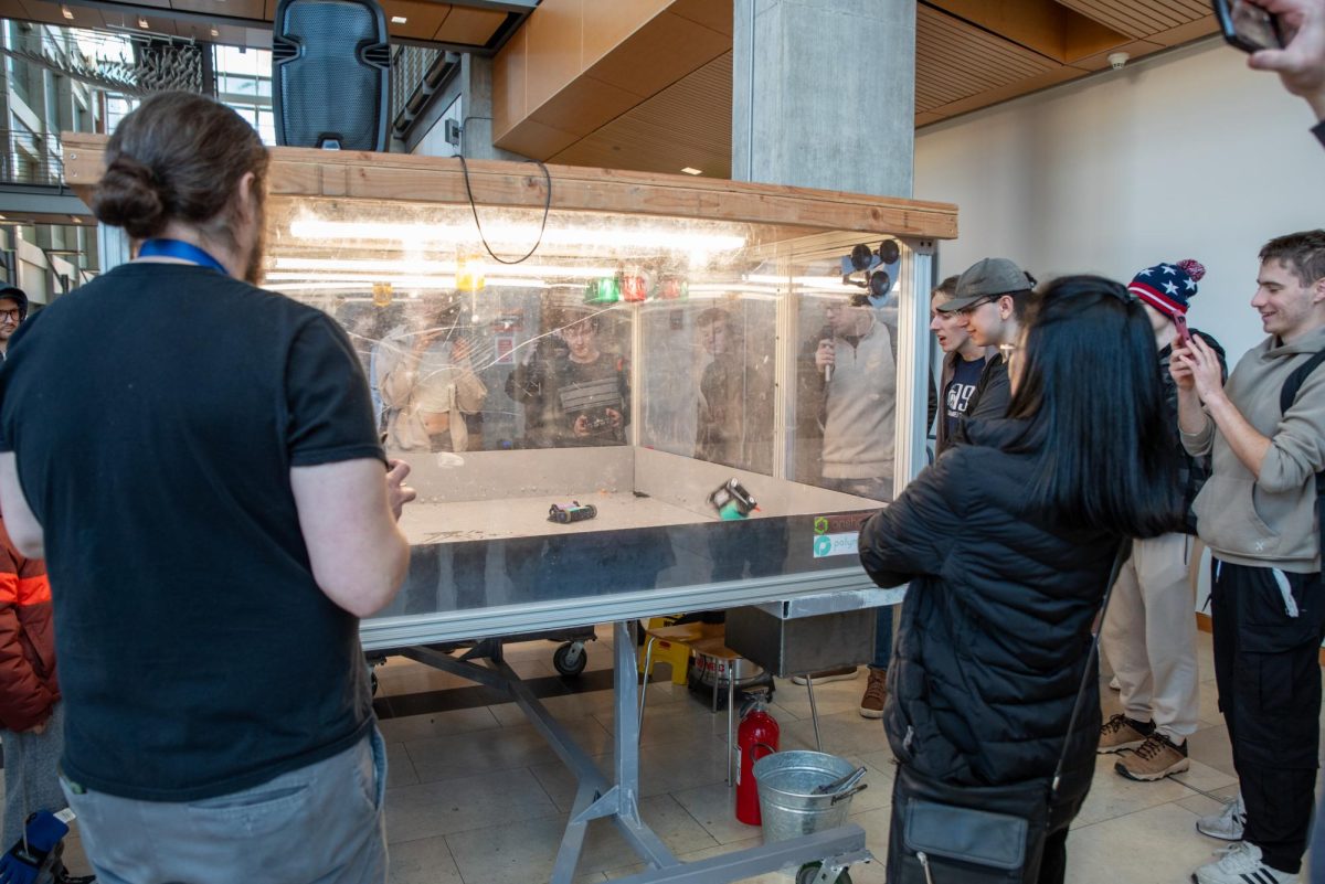Robots, Kid Copperhead (left) and Bobot, fight in an arena in the Kelley Engineering Atrium January 24, 2026. Kid Copperhead took the win at the annual event which was livestreamed on the Dam Robotics club Youtube channel.
