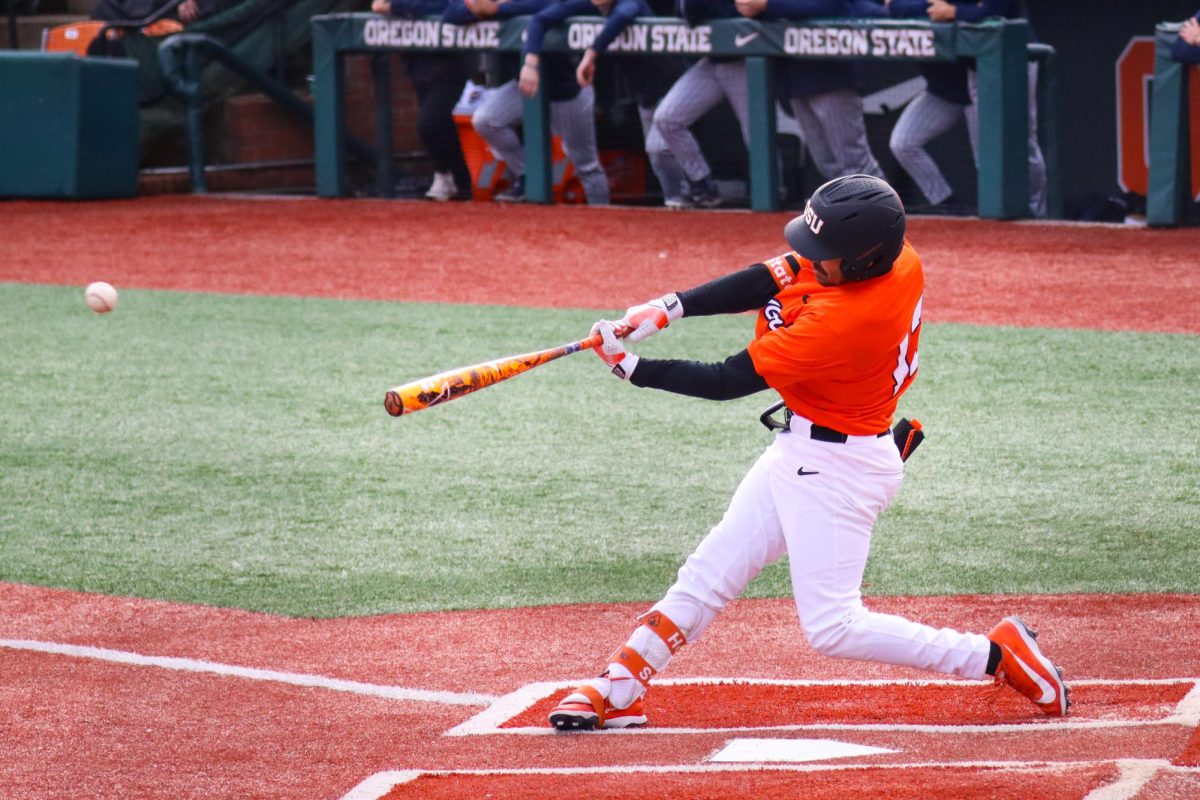 Oregon State’s Jacob Galloway (13) swings and hits the ball in their game against Xavier University at Goss Stadium on March 8, 2026. OSU claimed victory with a score of
17-2, and clinched the series victory.