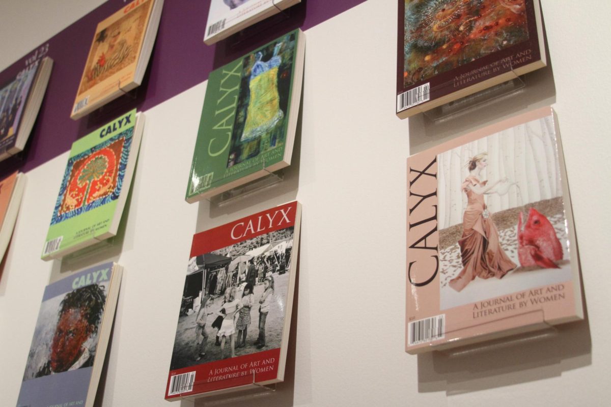 Past Calyx publications are displayed on the wall starting from 1976 all the way to the present day.