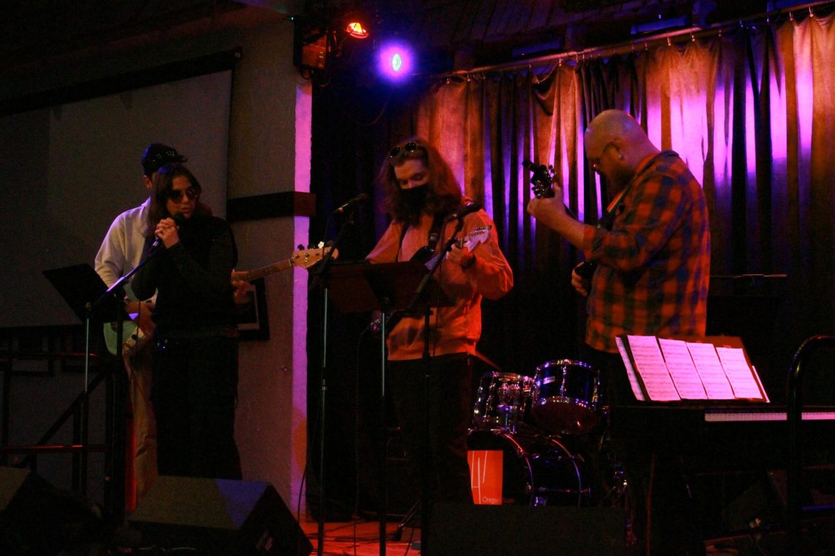 The student band, “The Chrissy Bees,” plays an original song.