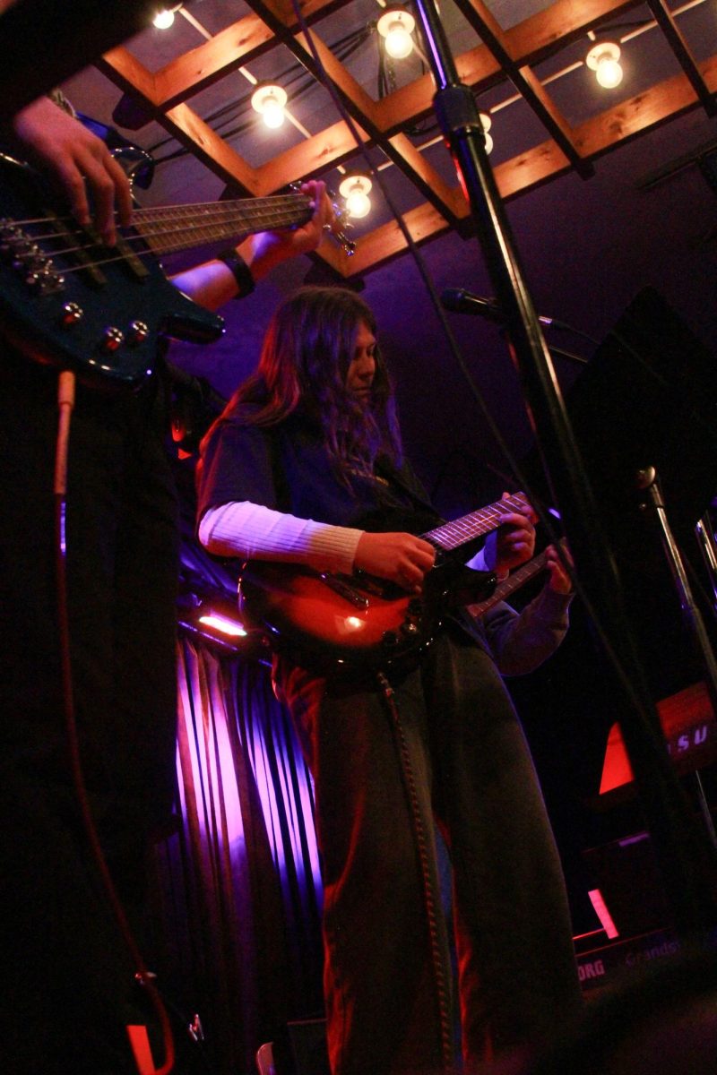 One of the guitarists for the student band, “Theoretical Beard,” plays alongside her peers as they cover “American Idiot” by Green Day