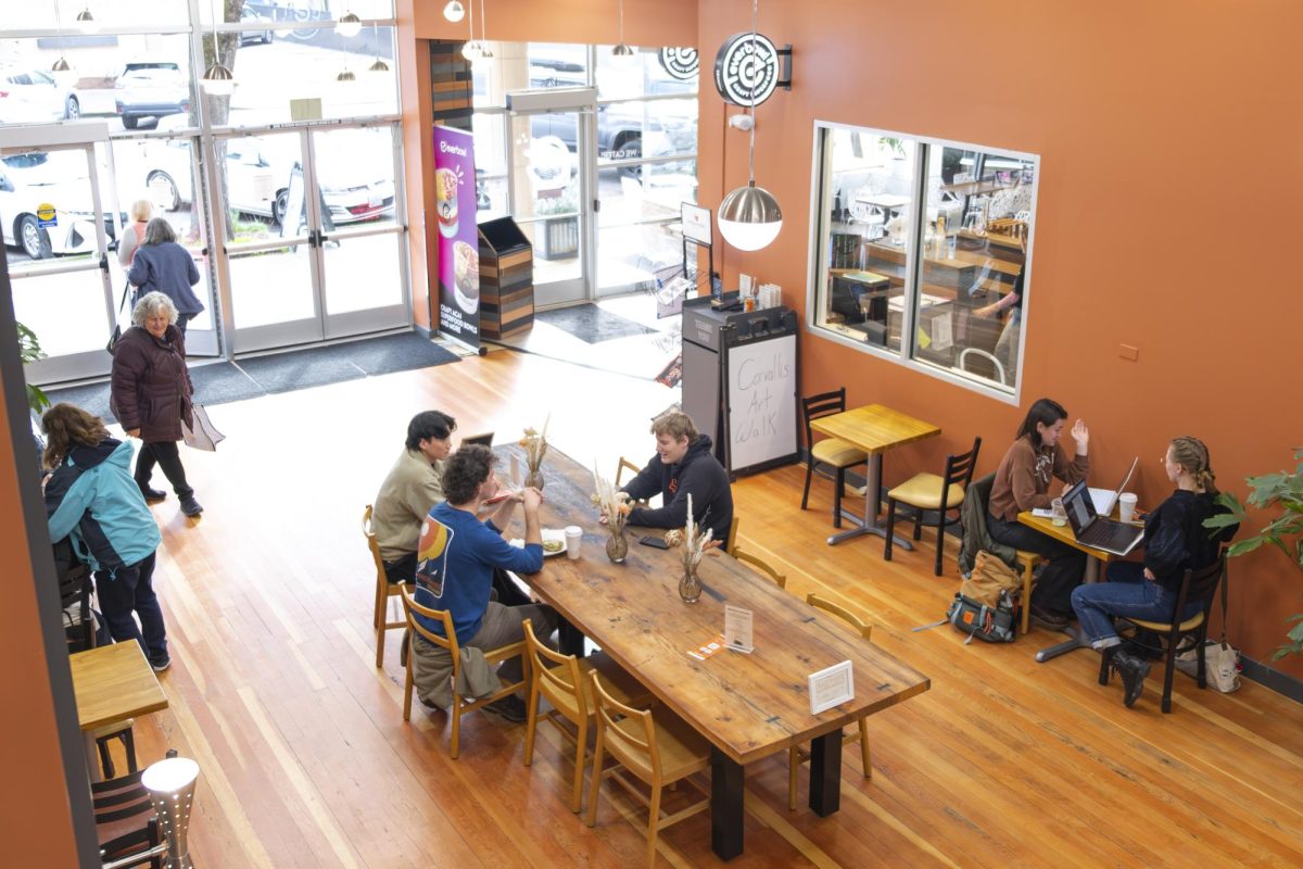 Customers sit and talk inside The Plaza in downtown Corvallis, Oregon, on Feb. 20. The Plaza is one of more than 14 downtown businesses owned by a local entrepreneur and recently opened as a communal gathering space.