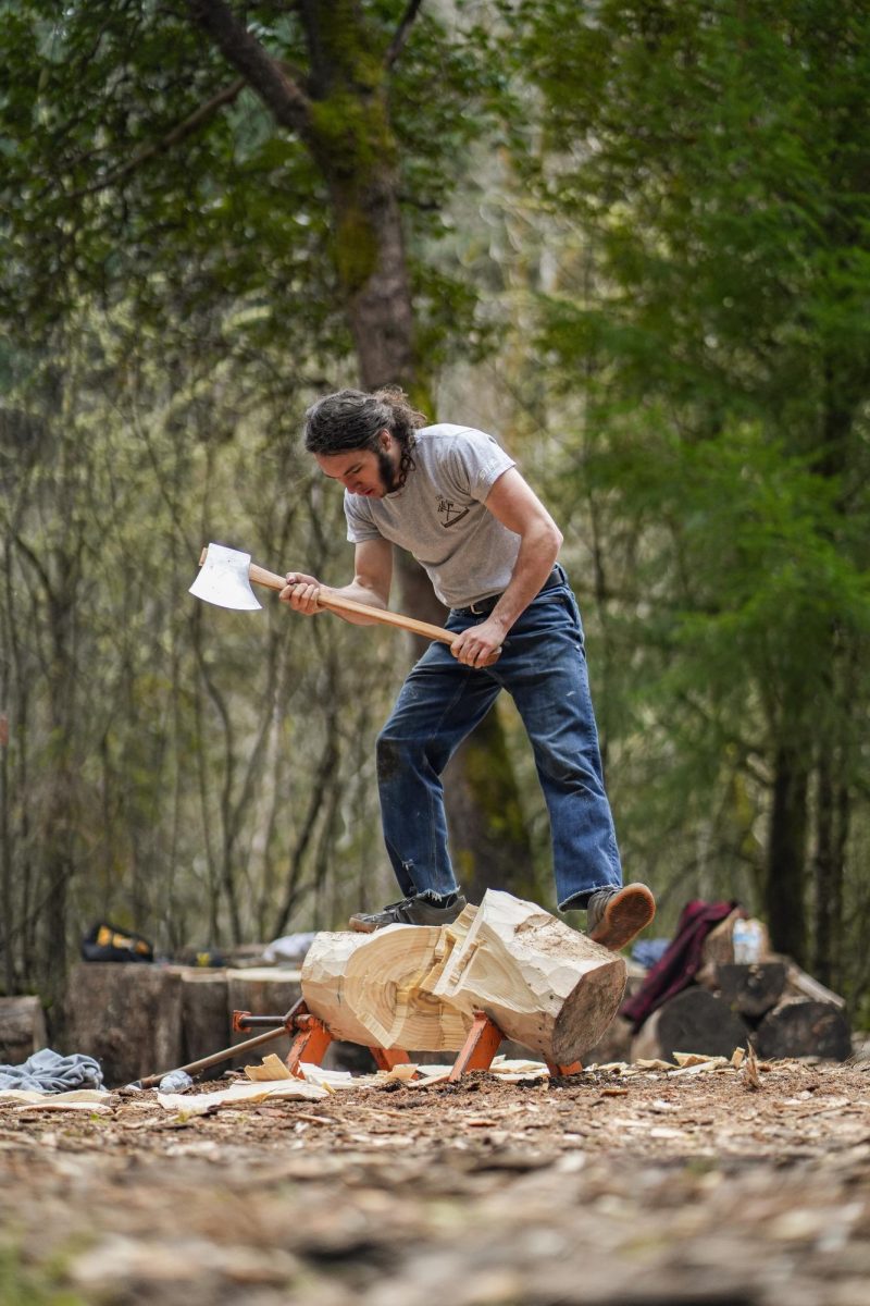 An Oregon State Logging Sports Team member stands on his severed block aftercompleting a horizontal speed chop