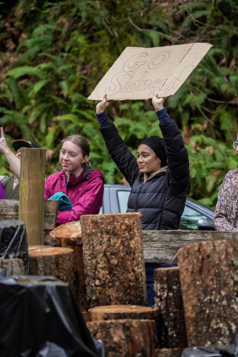 Friends of an OSU Logging Sports participant hold up a supportive sign during theSpring Thaw Competition