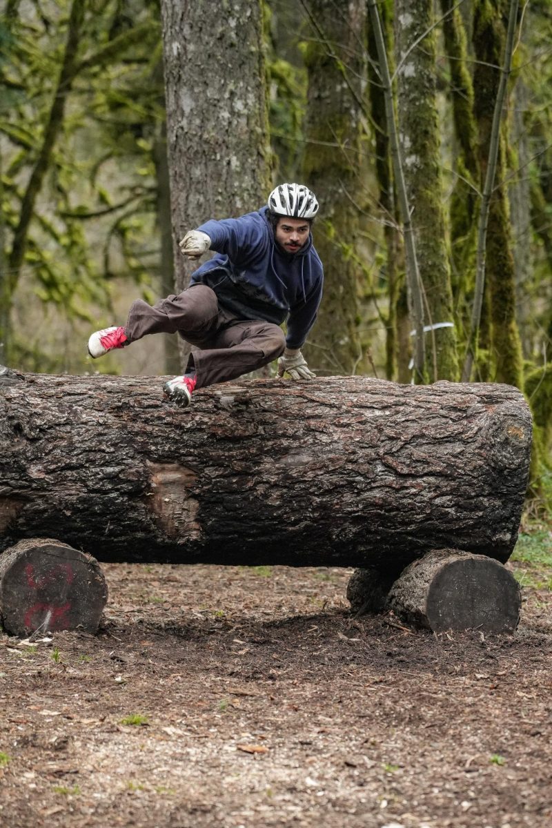 Oregon State Logging Team member jumps a horizontal tree log