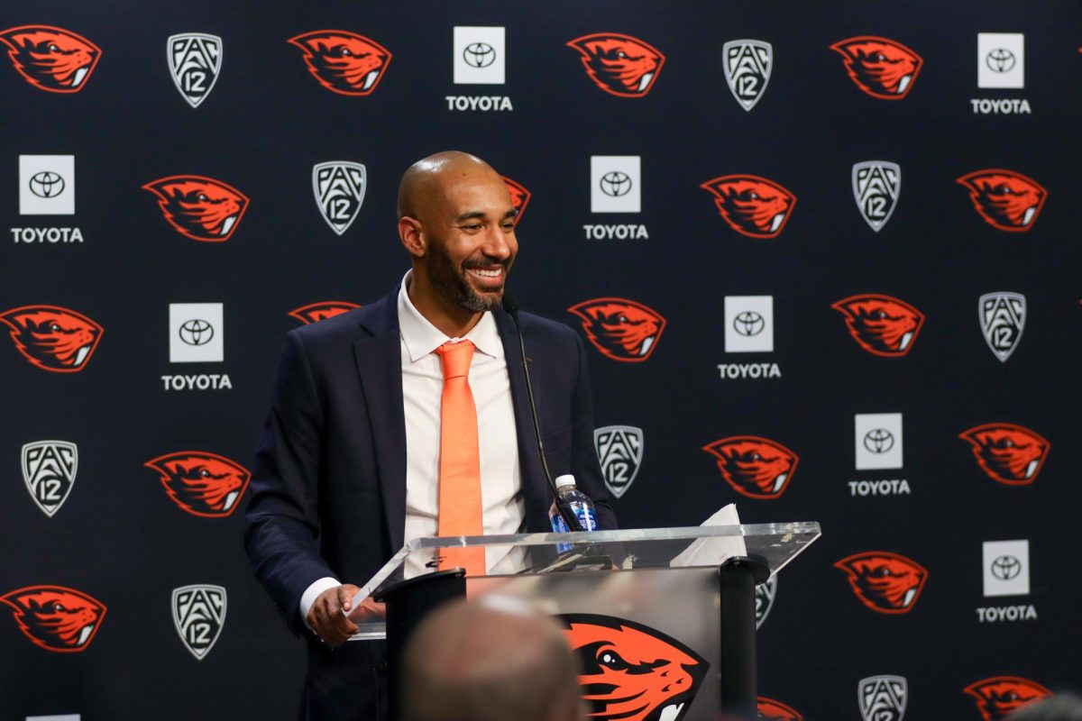 A man stands at a podium smiling.