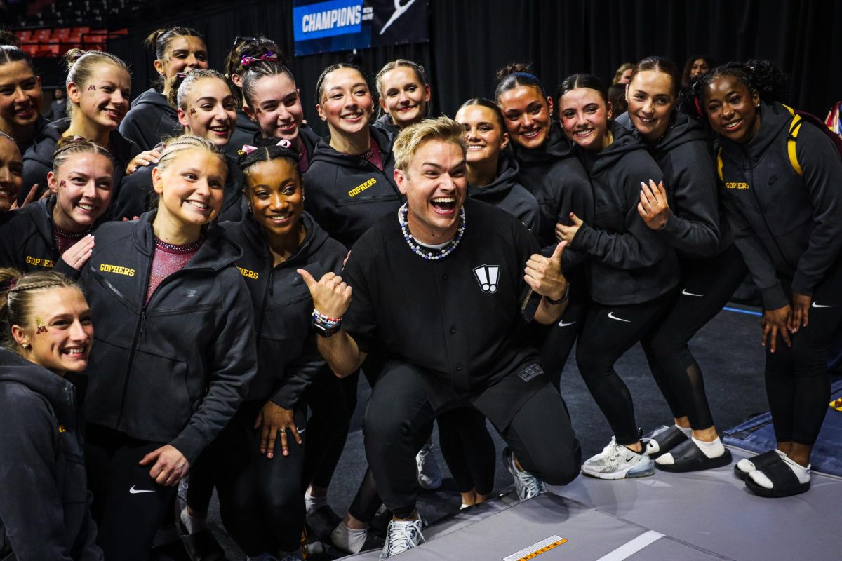 Minnesota University gymnastics poses for a group photo.