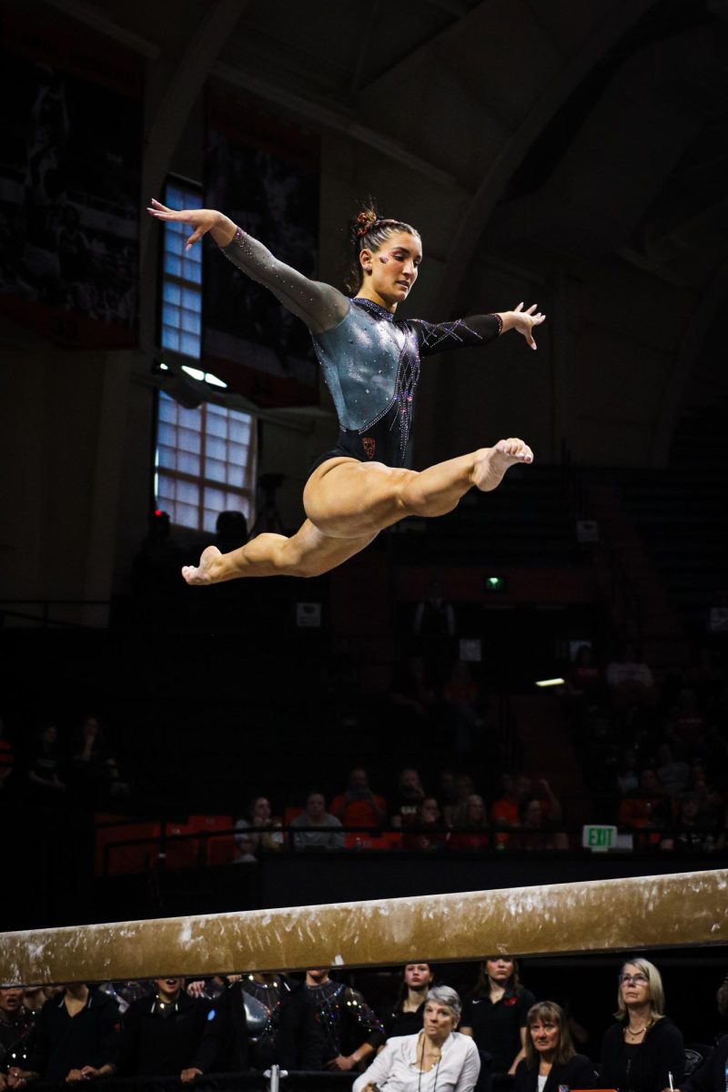 Sophia Esposito performs a split leap on the beam.