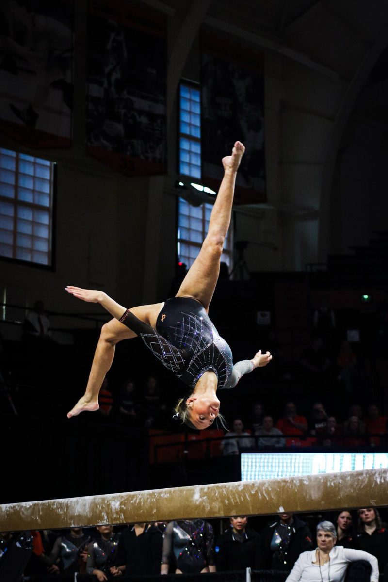 Kaylee Cheek performs a front aerial on the beam.