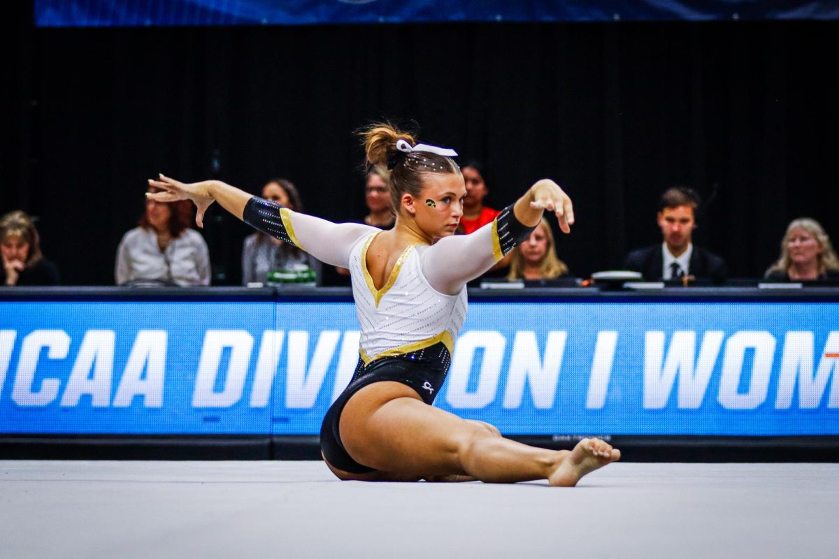 Stella DePaola poses on the floor during her floor routine.