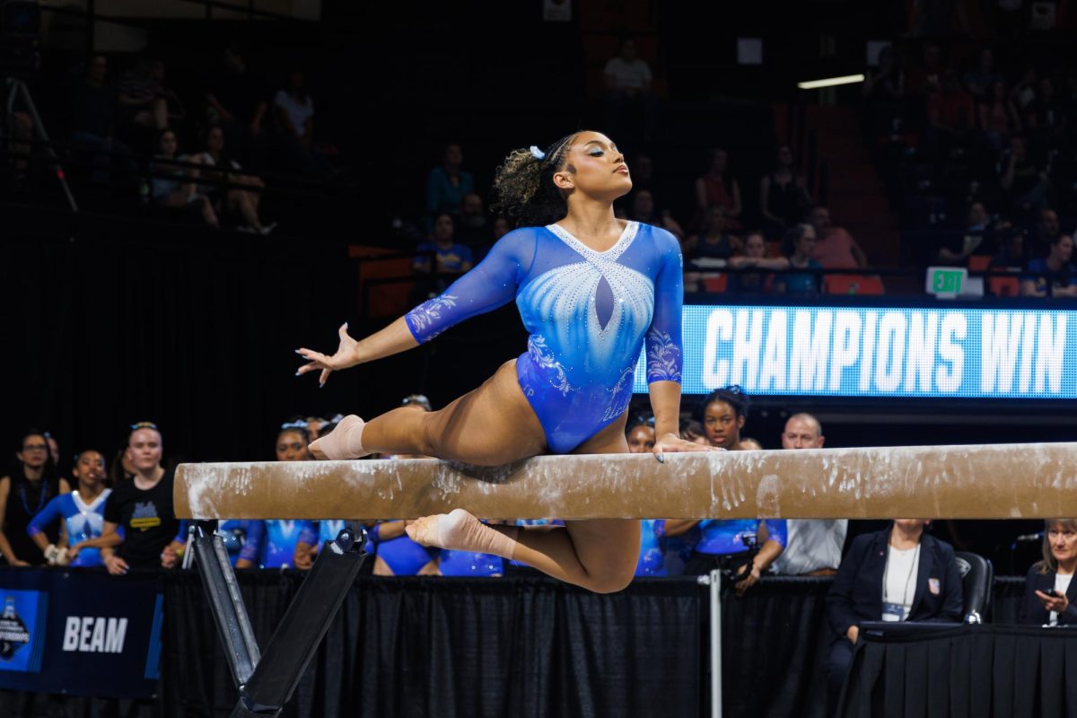 Sydney Barros, UCLA gymnast, holds a pose during her beam routine.