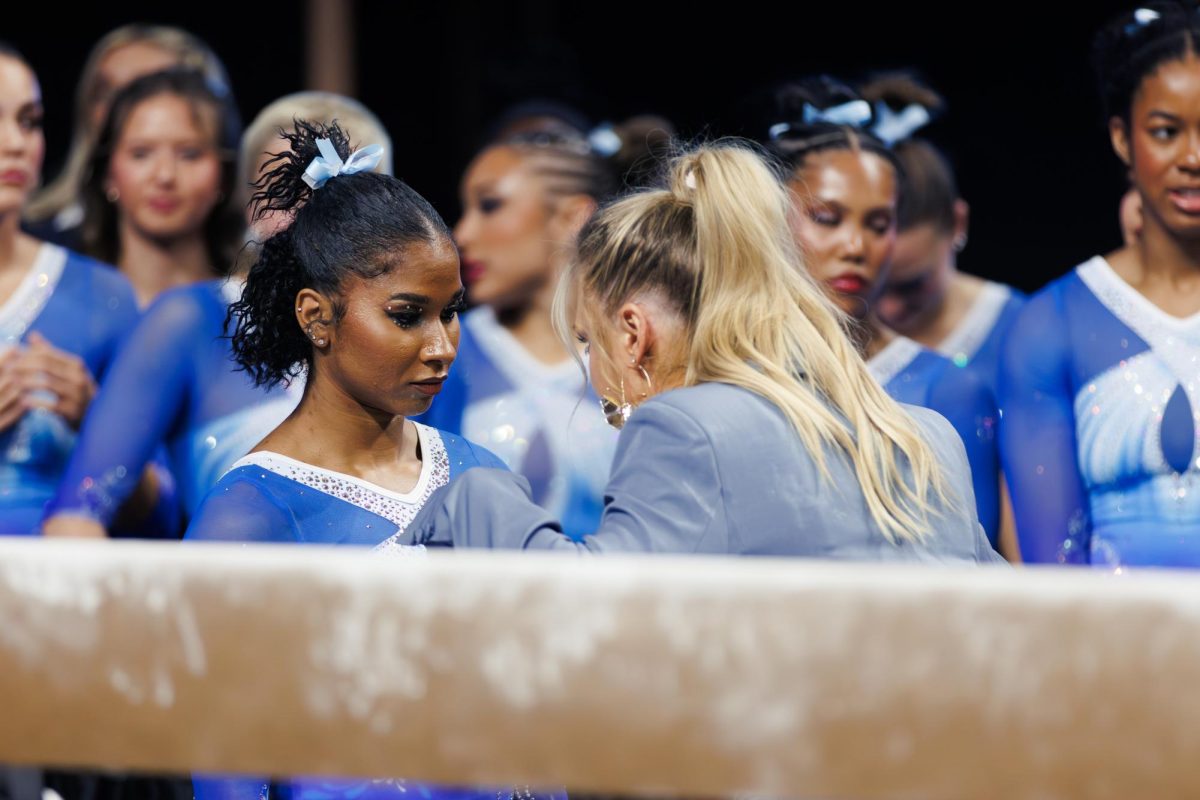 Jordan Chiles, UCLA gymnast, speaks with coach Lucy Dagen before her beam performance.
