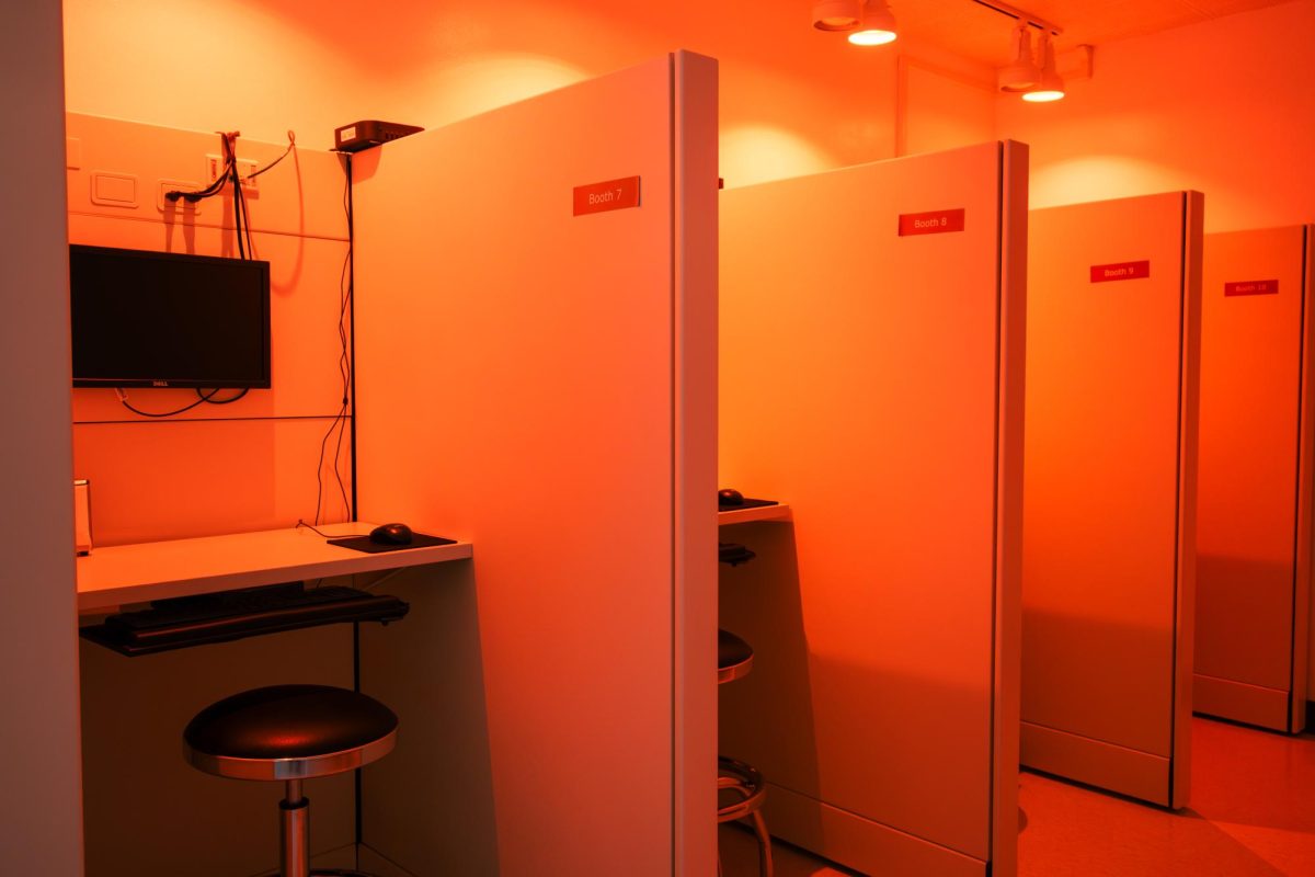 Multiple booths for sample testing are lit with red lights.