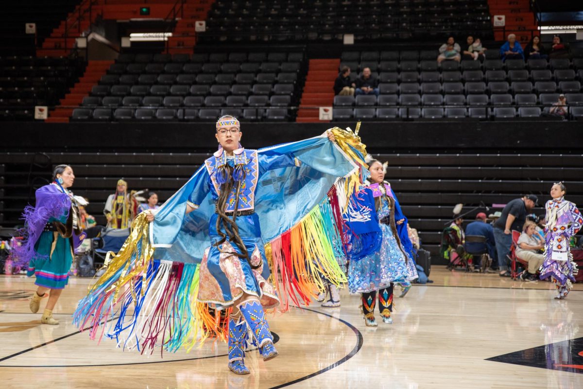 Women in indigenous clothing dance.