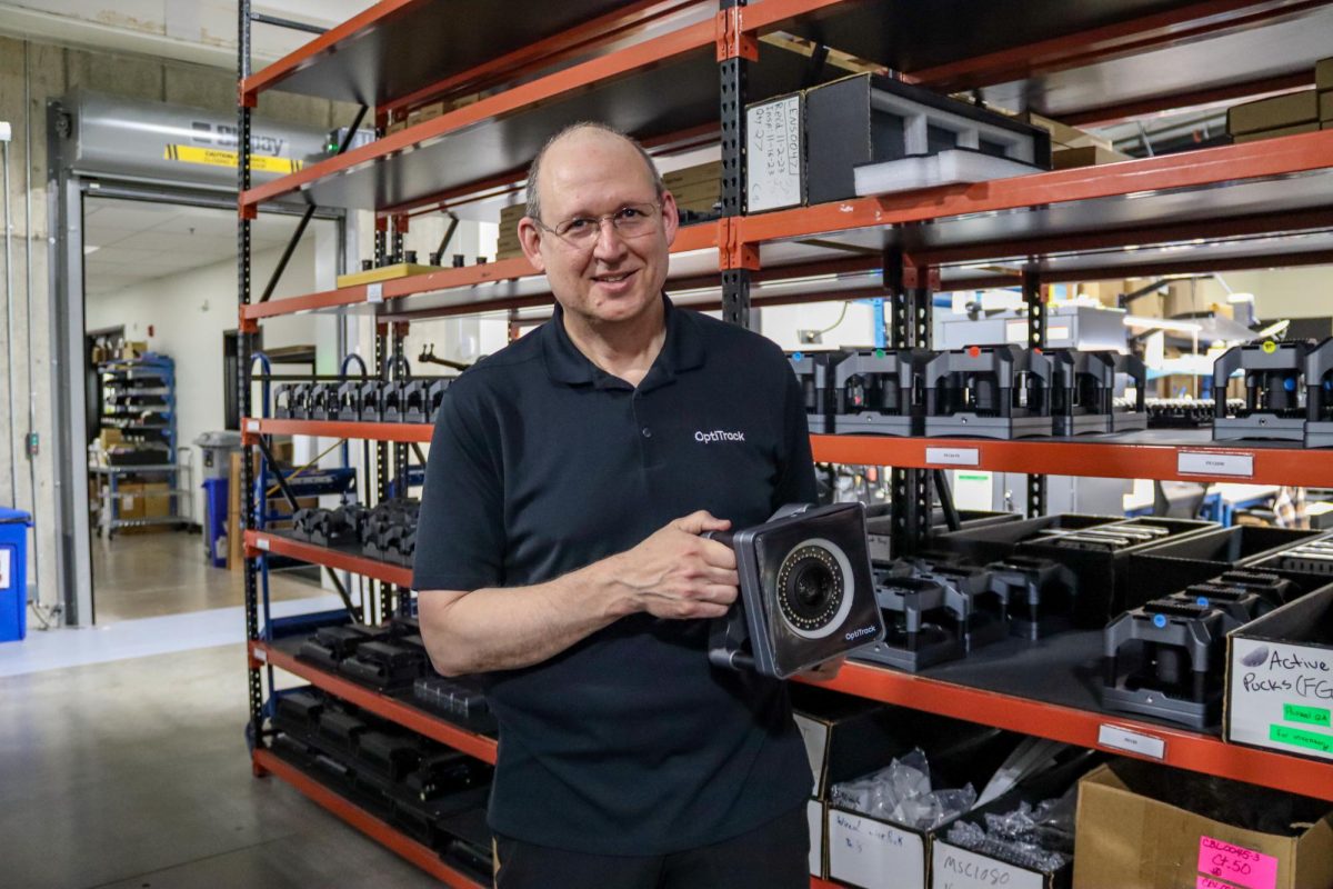 Marc Alley, Vice President of Operations, holds one of OptiTrack’s motion capture
camera systems inside the company warehouse in South Corvallis on Thursday, May 14,
2026.