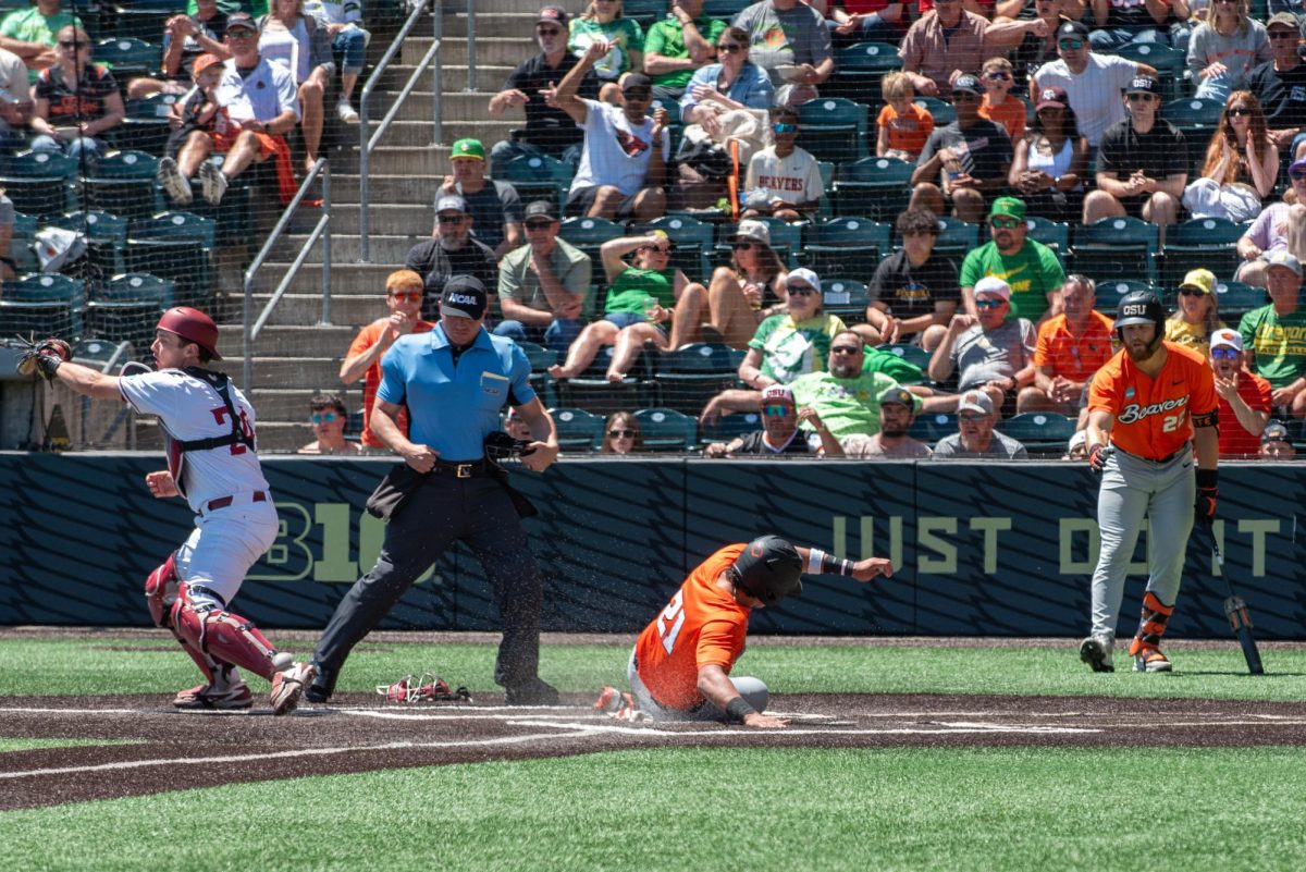 A baseball player slides into home plate.