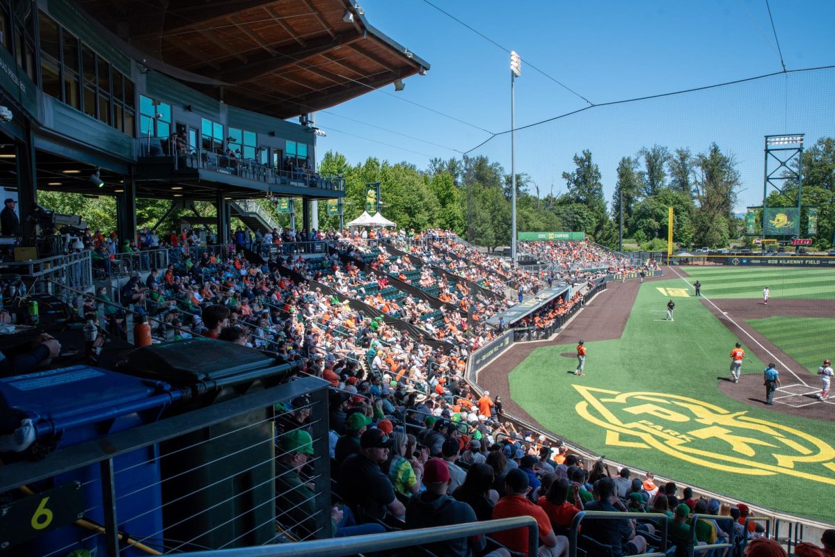 A wide view of the fans in the stands and third base and home plate.