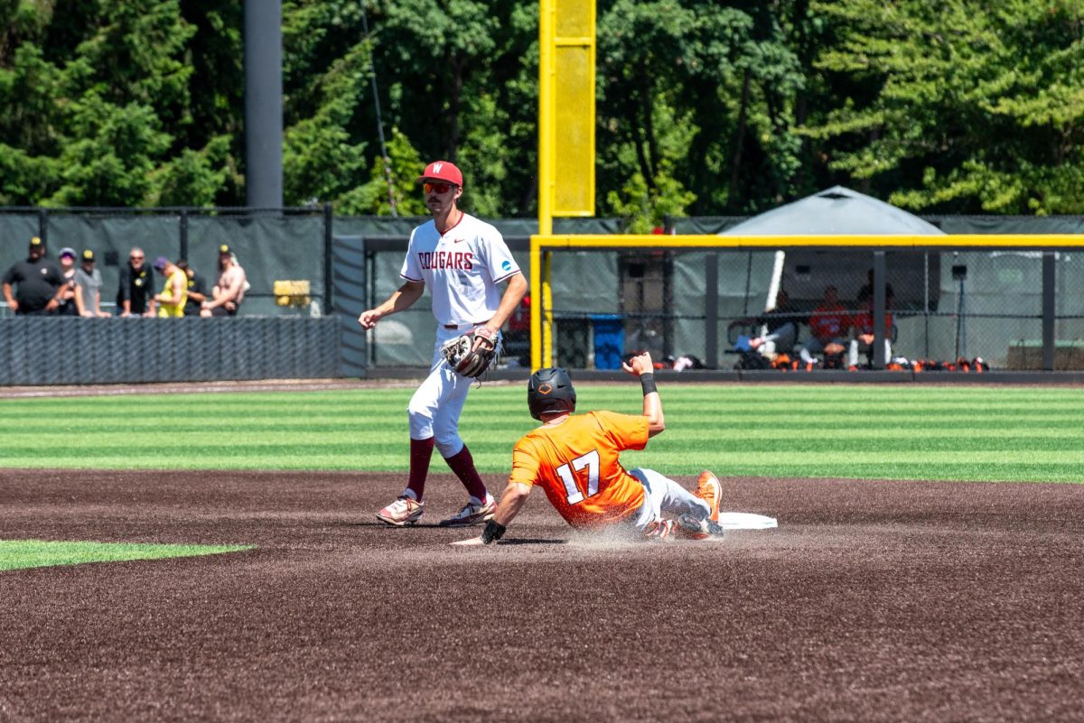 An OSU baseball player slides into second base.