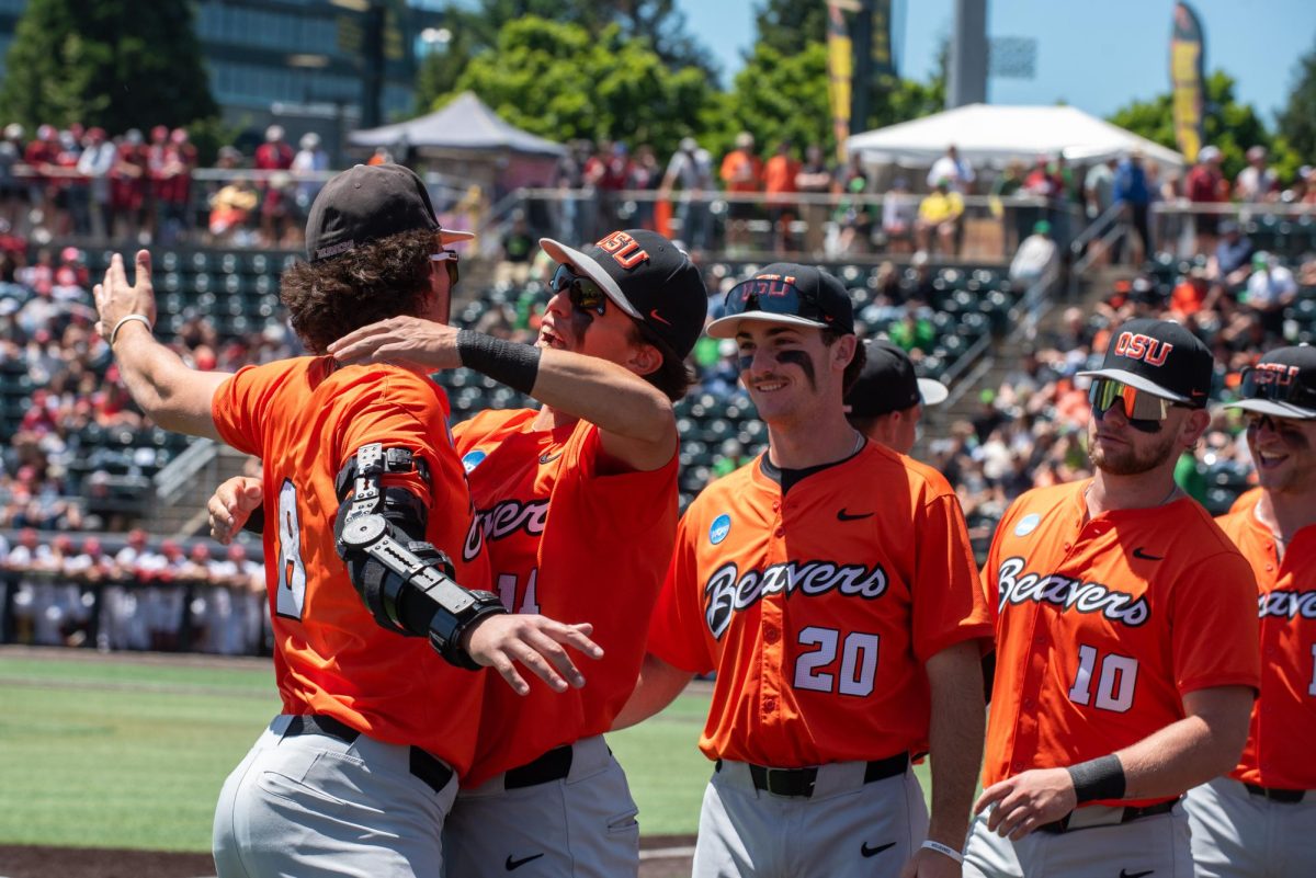 Two baseball players go in for a hug.