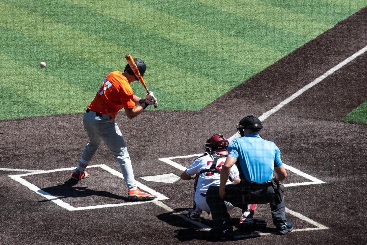 An OSU baseball player bats at home plate.