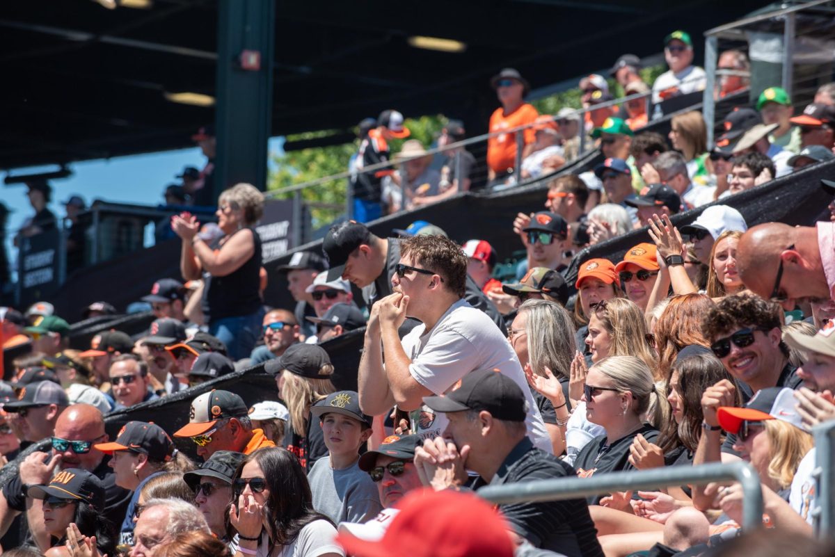 A man in the middle of the audience whistles.