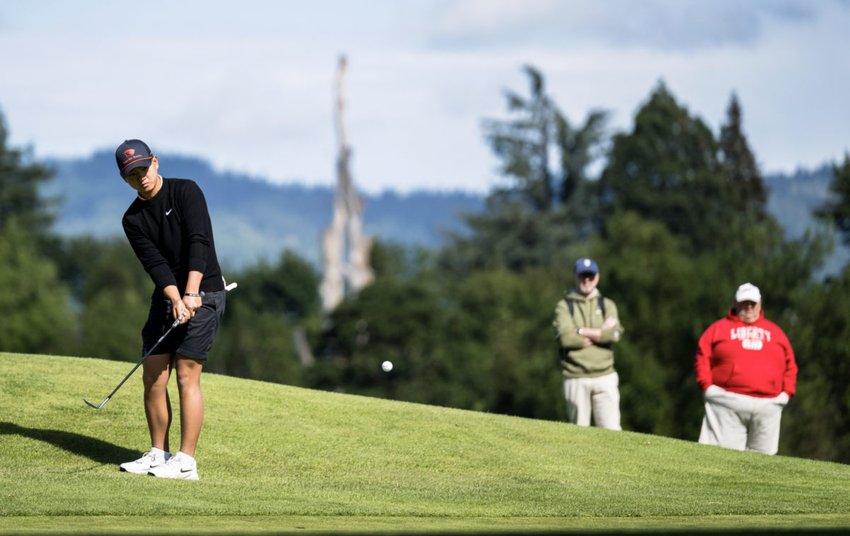 A man hits a golf ball.