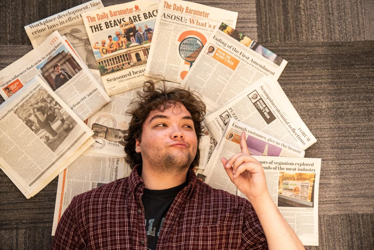 Daily Barometer News Editor Fox Perez lays down on the floor in the Orange Media Network office inside the Student Experience Center at Oregon State University on May 28. 