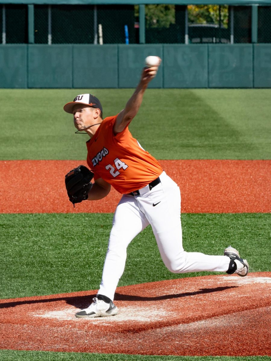 A man pitches a baseball.