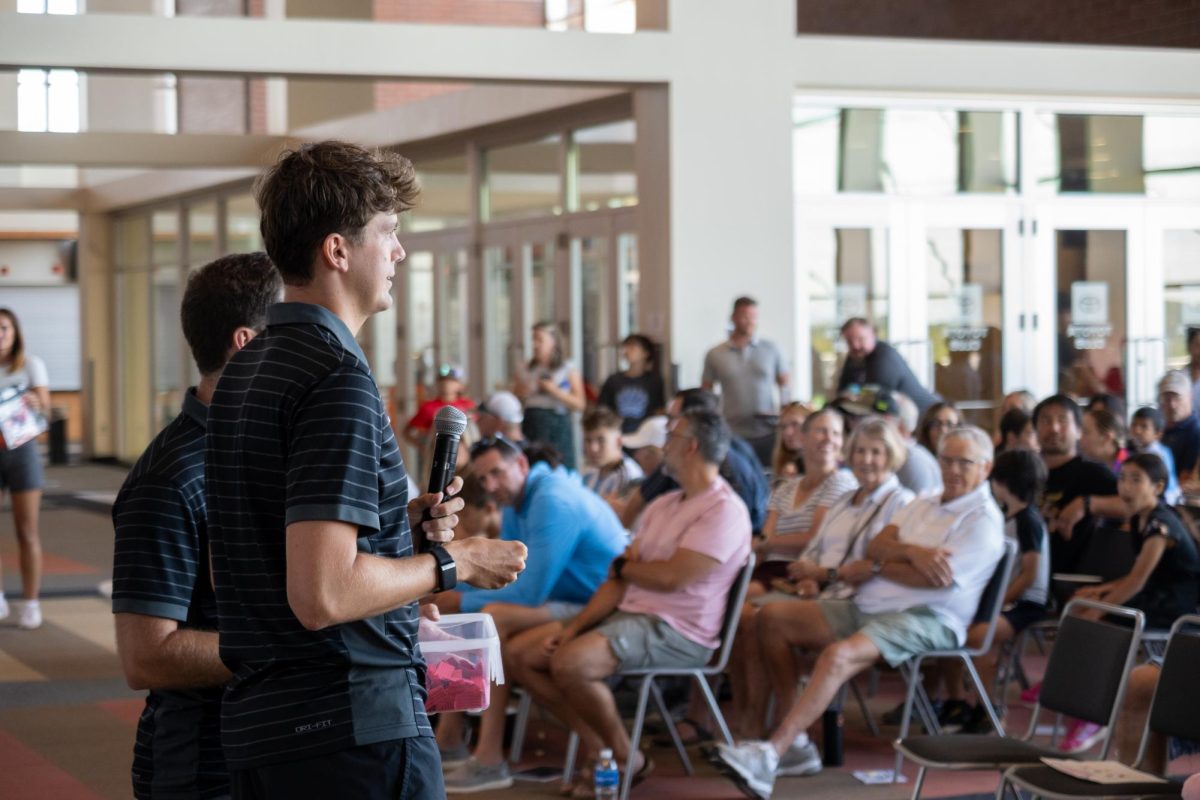People speak to a crowd