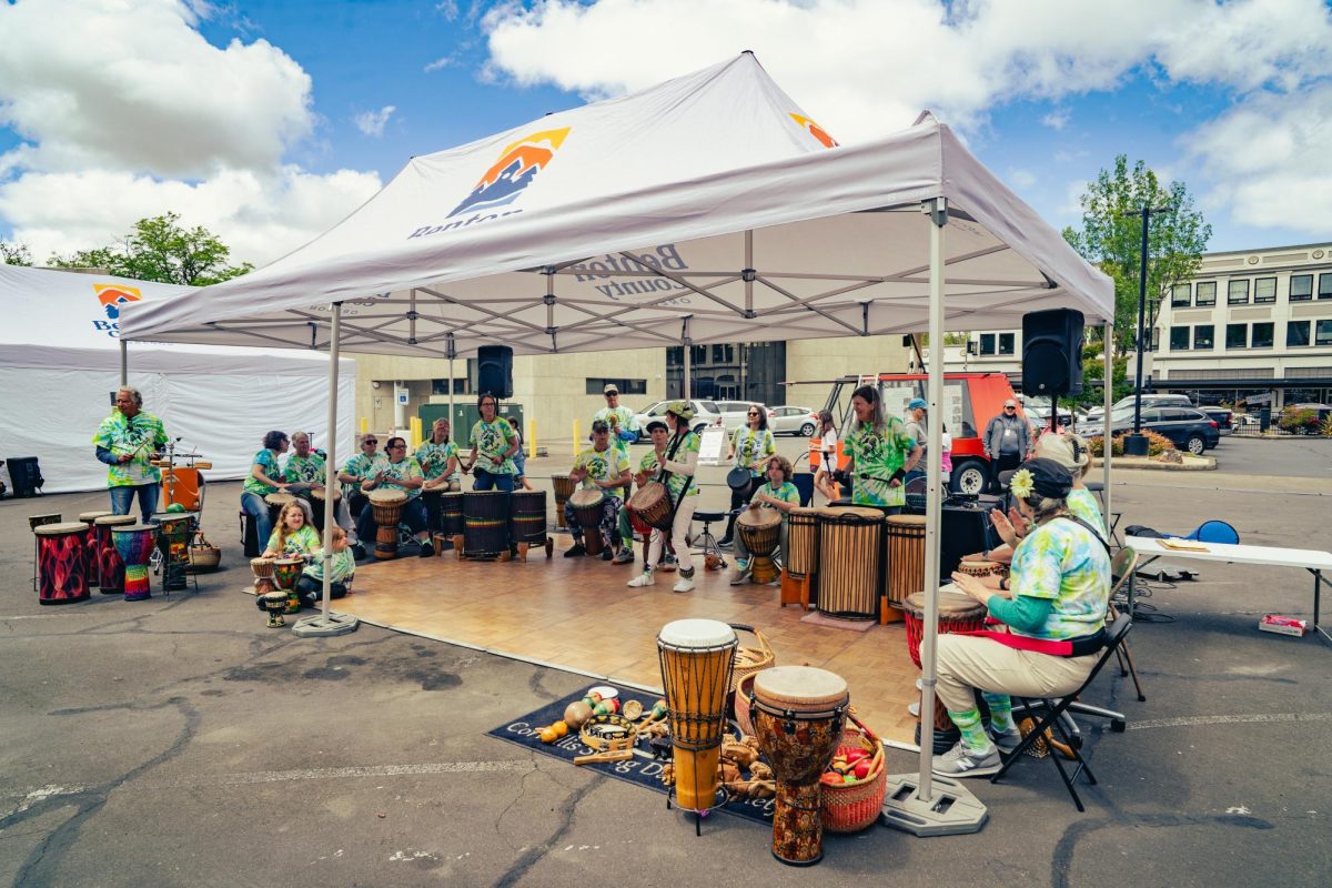 A drum circle plays under a tent