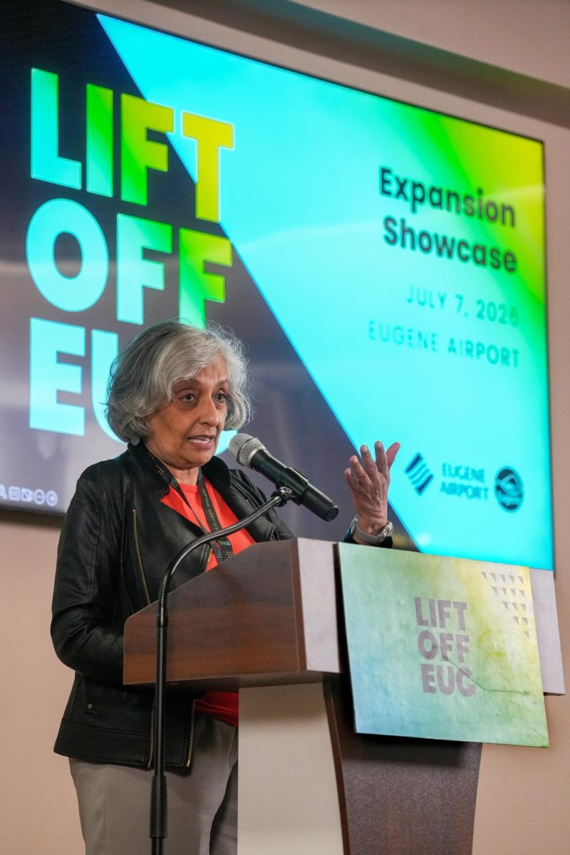 A woman stands at a podium.
