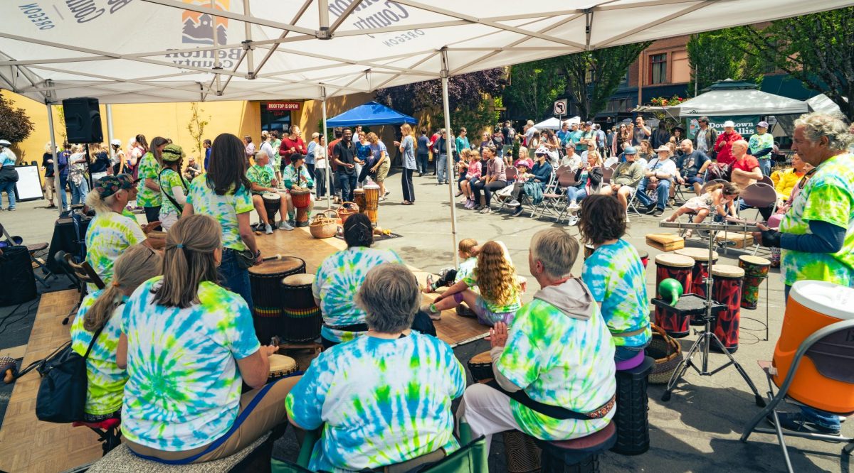 A drum circle plays for a group of people